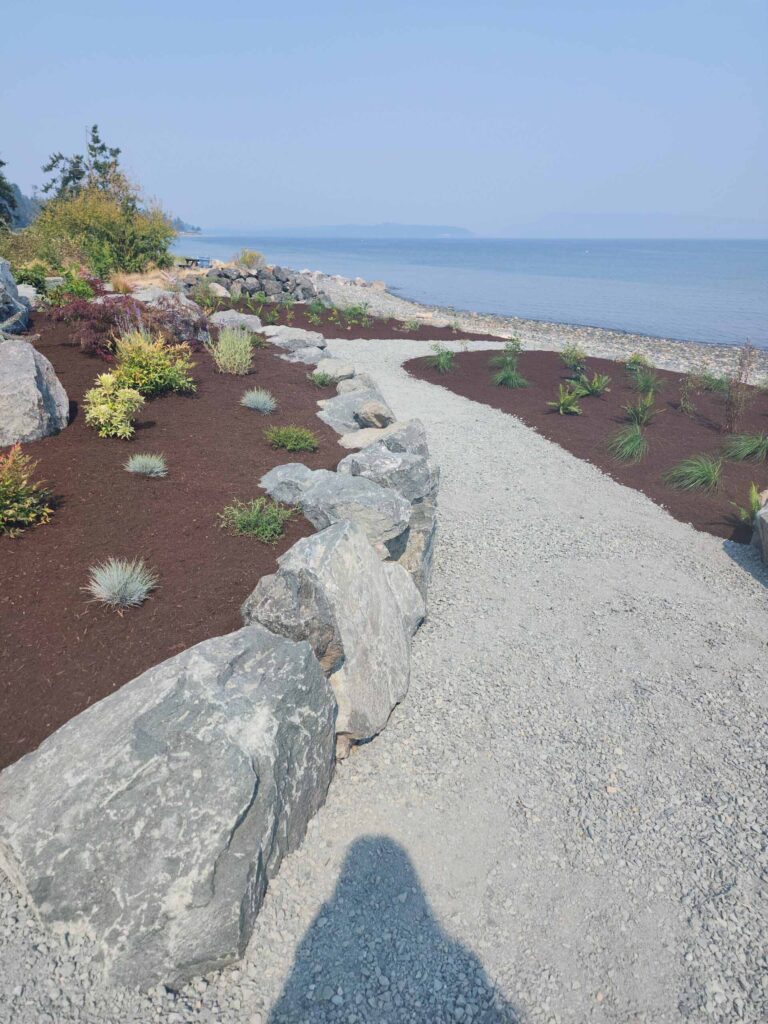 20230825_120055-scaled Landscaping example: stone retaining wall and landscaped areas leading to the beach.
