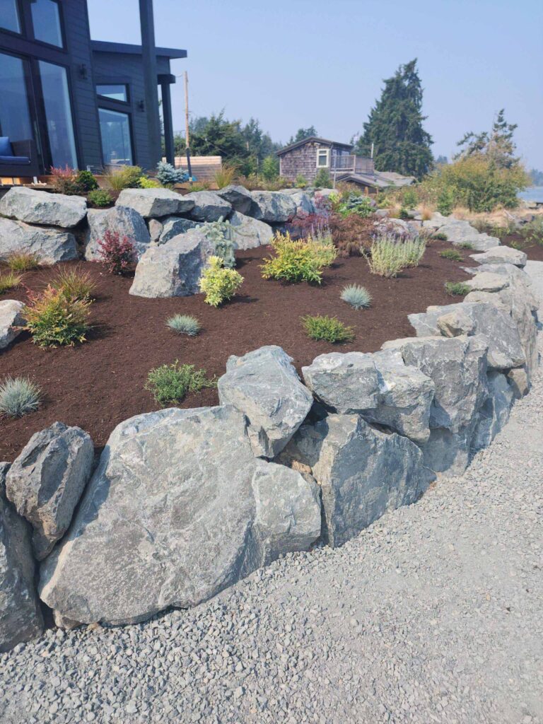 20230825_120104-scaled Rock retaining walls with a garden bed between.