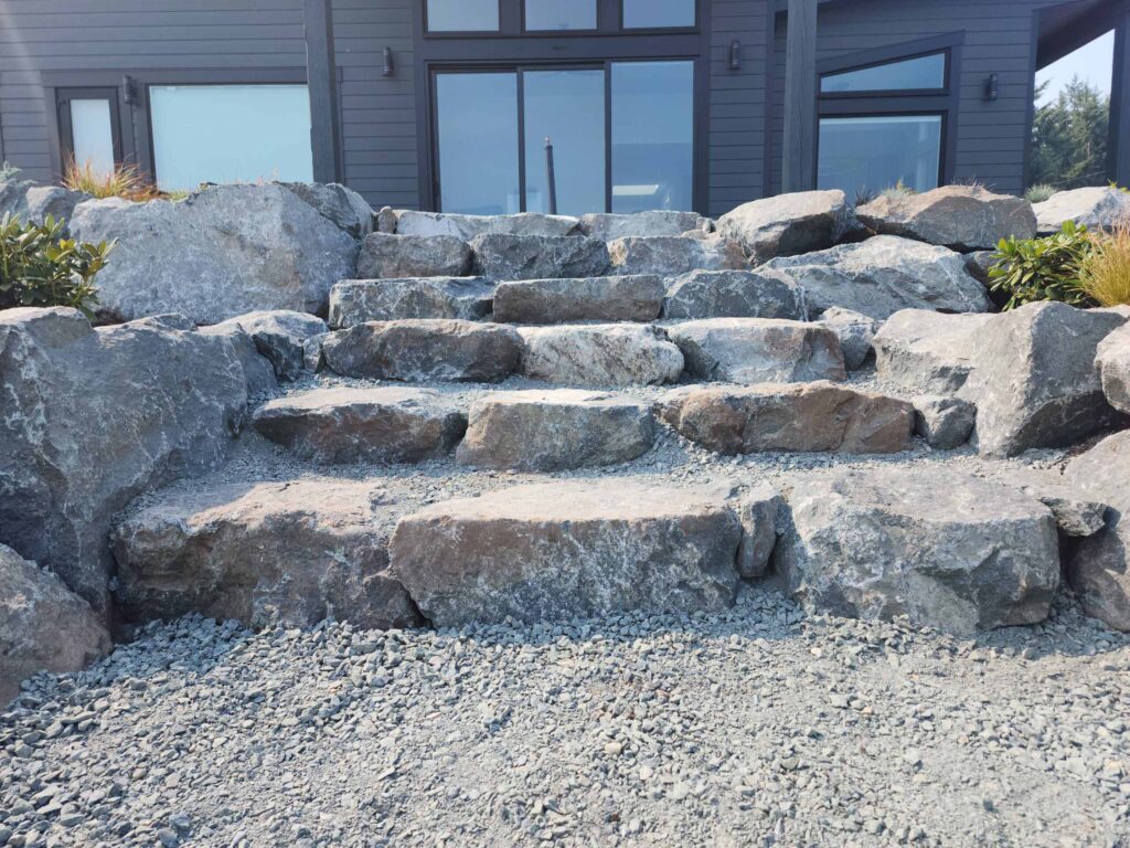 20230825_121040-scaled Landscaping example: close up of stone stairs on ocean revetment project.