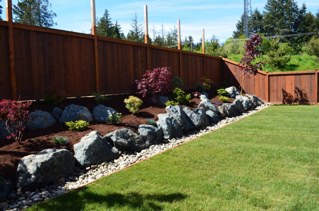 DSC_0825-scaled Landscaping example: alternative view of flower bed against a fence with single retaining wall/feature.