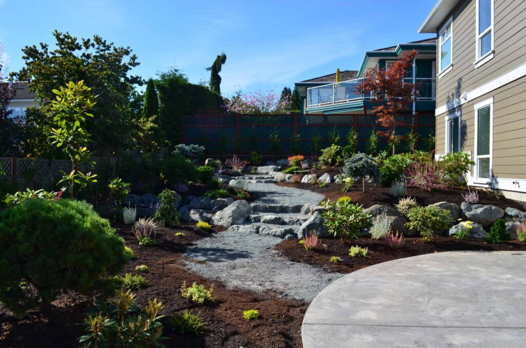 DSC_1059-scaled Landscaping example: Complete yard overview of winding pathway within low maintenance flower beds.