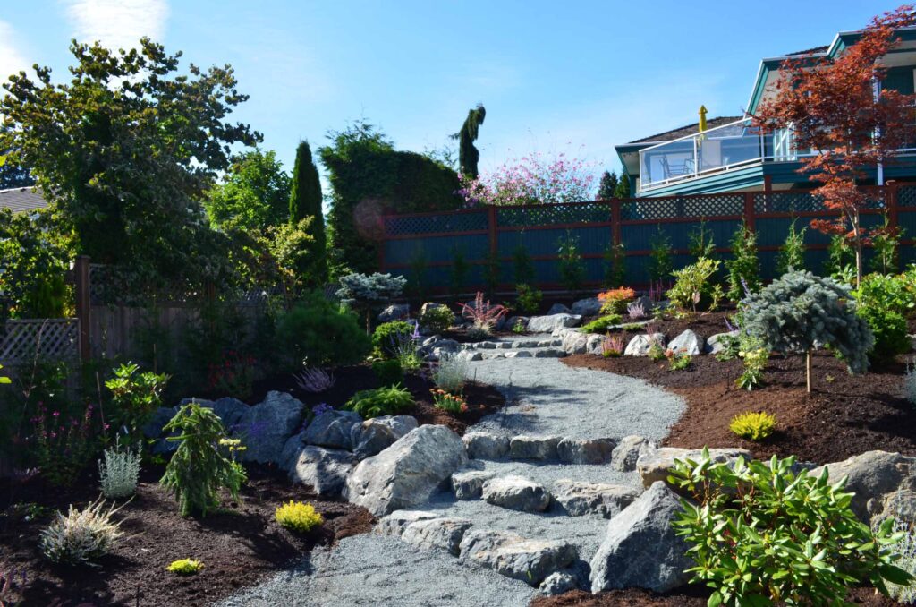 DSC_1062-scaled Landscaping example: alternative view of flower beds and pebbled pathway.