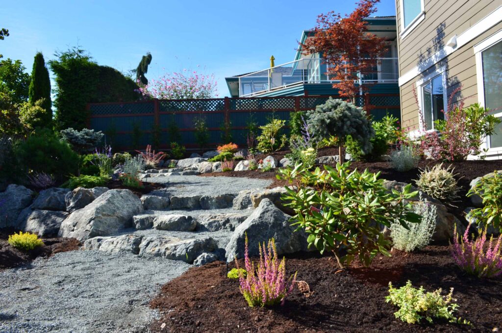 DSC_1065-scaled Landscaping example: Overview of shrub/flower garden with a natural pathway out of stones and pebbles.