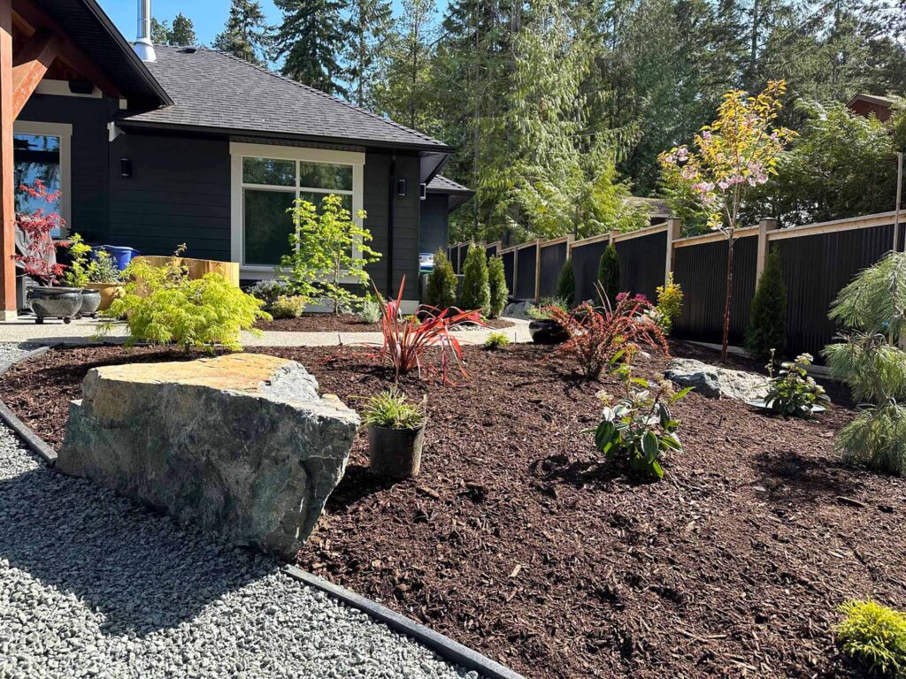 IMG_0539-scaled-2 Landscaping example: Simple garden bed with a large rock feature.