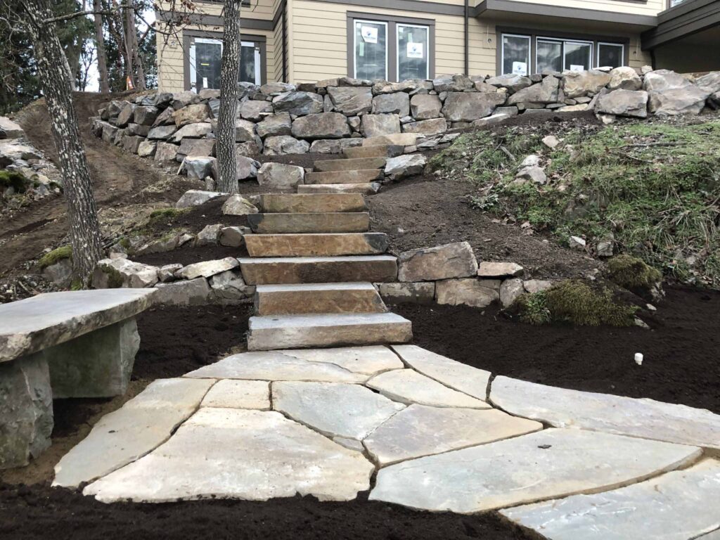 IMG_0550-scaled Landscaping example: View of a large stone retaining wall, stone stairs, and a stone base with a stone bench.