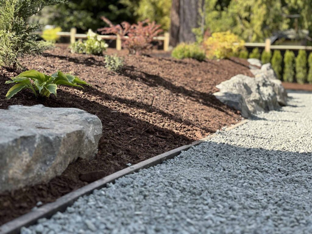 IMG_0556-scaled Landscaping example: Close up of a retaining wall next to a gravel driveway.