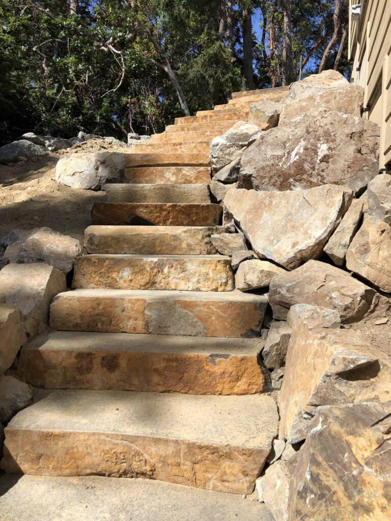 IMG_0891-scaled Stone stairs with large rocks on either size.