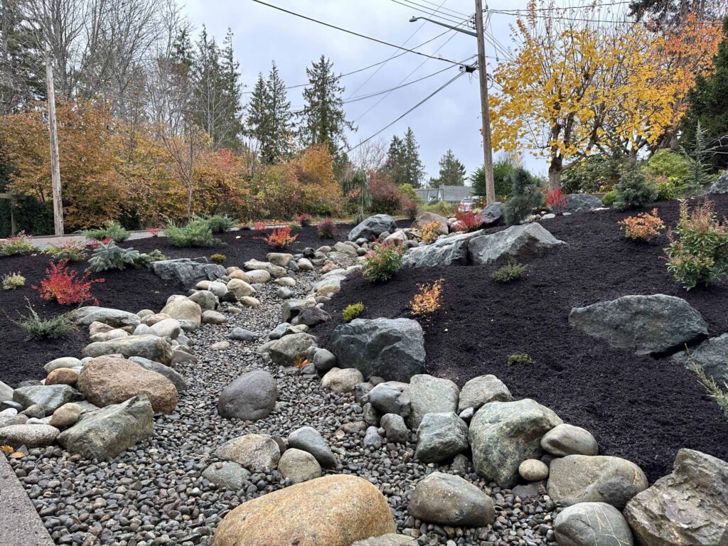 IMG_1526-scaled Landscaping example: Close up of a stone lined creek between two garden beds.