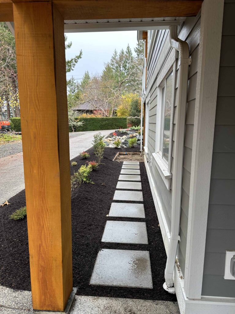 IMG_1593-scaled Landscaping example: square tiled stone path along the side of a home.