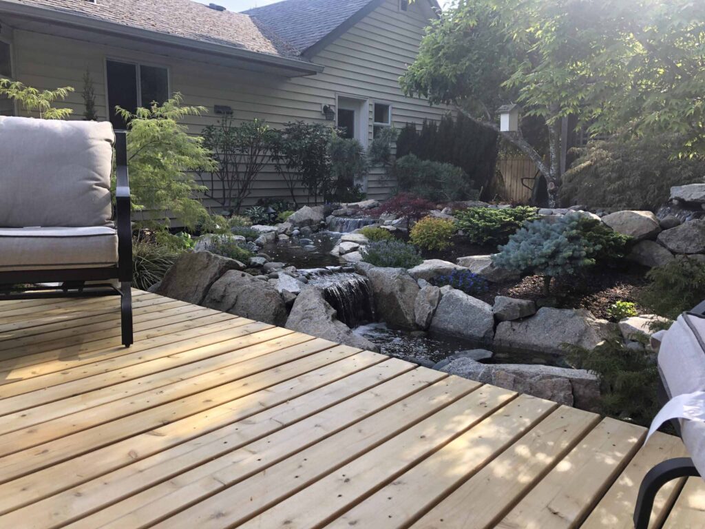 IMG_2044-scaled Landscaping example: A view of a waterfall/creek feature from the client's deck.