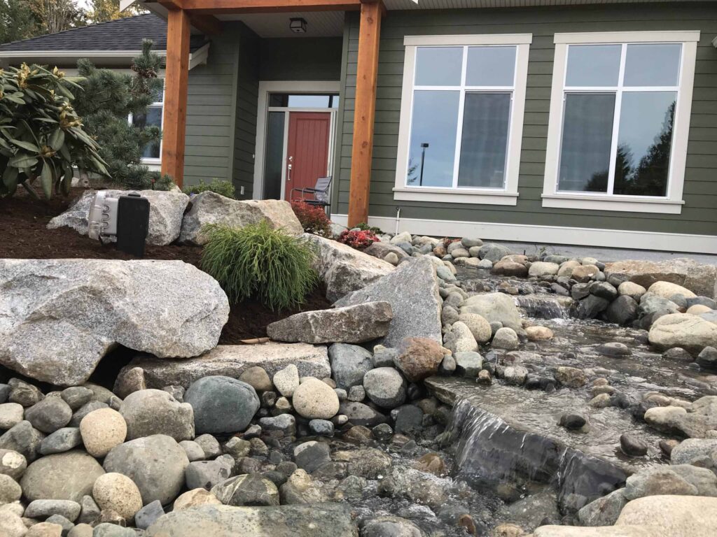 IMG_2205-scaled Landscaping example: close up of mini waterfalls with a home in the background