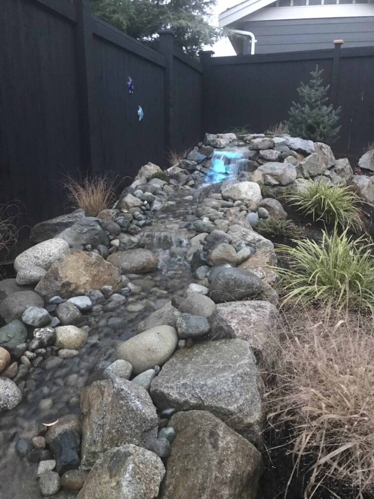 IMG_2409-scaled Landscaping example: small waterfall with blue lighting (farther away view)