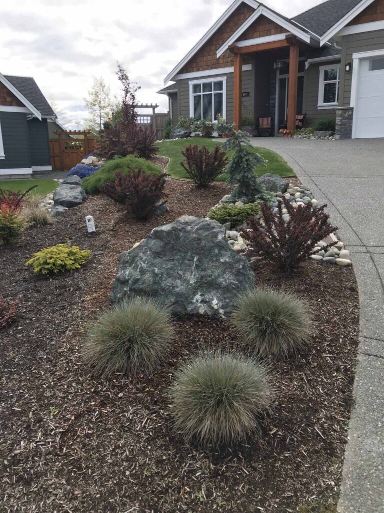 IMG_3031-scaled View of home from the end of driveway, showing landscaped rock garden.